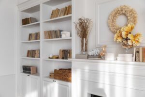 A minimalist interior design of a bookcase blends books and decorative items, showcasing style with a balanced, uncluttered look that highlights simplicity and elegance.